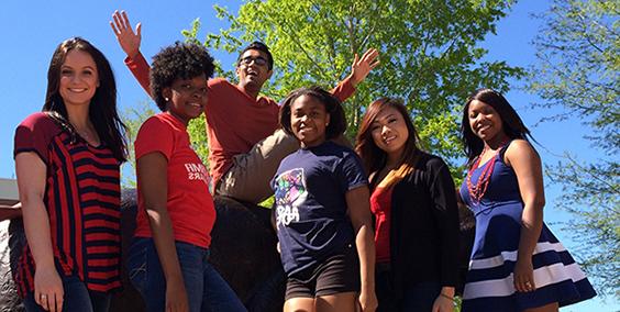 a group of students smiling outside